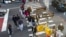 Shoppers holding bags cross Broadway on Black Friday in New York, Nov. 24, 2023.