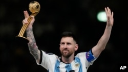 FILE - Argentina's Lionel Messi waves after receiving the Golden Ball award for best player of the tournament at the end of the World Cup final soccer match between Argentina and France in Lusail, Qatar, Dec. 18, 2022. 