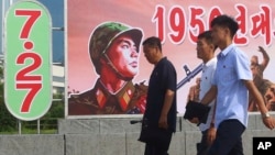 Citizens walk in the Pothonggang District of Pyongyang, North Korea, July 27, 2023, on the 70th anniversary of an armistice that halted fighting in the 1950-53 Korean War. 