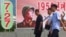 Citizens walk in the Pothonggang District of Pyongyang, North Korea, July 27, 2023, on the 70th anniversary of an armistice that halted fighting in the 1950-53 Korean War. 