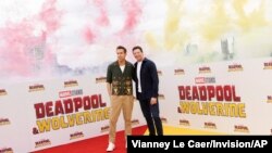 Ryan Reynolds, left, and Hugh Jackman pose for photographers at the photo call for the film 'Deadpool & Wolverine', July 12, 2024 in London. 