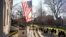 FILE - People take photographs near a John Harvard statue, Jan. 2, 2024, on the campus of Harvard University, in Cambridge, Mass.