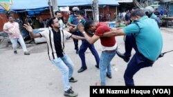 Police officers and a member of the youth wing of the ruling Awami League party thrash a BNP activist during the opposition party’s sit-in protest in Dhaka, July 29, 2023, demanding resignation of Prime Minister Sheikh Hasina.