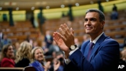 Spain's acting Prime Minister Pedro Sanchez applauds being chosen by a majority of legislators to form a new government after a parliamentary vote at the Spanish Parliament in Madrid, Spain, Nov. 16, 2023. 