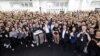 Tesla Chief Executive Officer Elon Musk, center, poses for a group photo at the Shanghai Gigafactory of the U.S. electric vehicle maker in Shanghai, in this handout image released on June 1, 2023. (Tesla/Handout via Reuters)