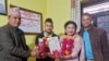 Same-sex couple Surendra Pandey, 2nd left, and Maya Gurung, pose for a photograph with their marriage registration certificate at Dorje village council office, located in the mountains west of Kathmandu, Nepal, Nov. 29, 2023.