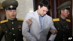 FILE - American student Otto Warmbier is escorted at the Supreme Court in Pyongyang, North Korea, March 16, 2016.
