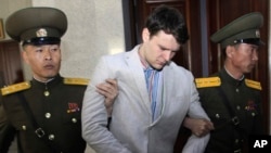 FILE - American student Otto Warmbier is escorted at the Supreme Court in Pyongyang, North Korea, March 16, 2016. He died in June 2017, shortly after he was flown home in a coma after almost a year and a half in North Korean captivity. 