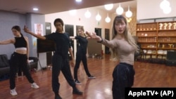 In this undated photo provided by AppleTV+, K-pop band Blackswan members practice a routine. (AppleTV+ via AP)