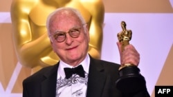 FILE - James Ivory poses with the Oscar for Best Adapted Screenplay for 'Call Me by Your Name,' during the 90th Annual Academy Awards on March 4, 2018, in Hollywood.