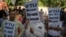 Activists of several student and left organizations hold placards during a protest against the arrest of the editor of a news website and one of its administrators after raiding the homes of journalists, in New Delhi, Oct. 4, 2023.