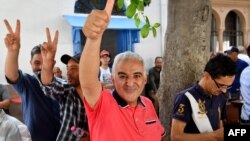 FILE: Journalist Zied el-Heni gestures upon his release on June 22, 2023, in Tunis. El-Heni, 59, was kept in custody after being questioned on June 20, evening over alleged "crimes through telecommunications" channels, his lawyer said at the time.