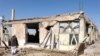 An Afghan man stands near a damaged house after the earthquakes in Sarbuland village, Zendeh Jan district of Herat province on Oct. 8, 2023. 