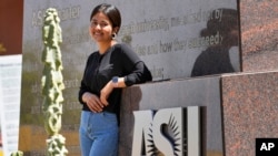 Fahima Sultani stands at the entrance of Arizona State University, April 7, 2023, in Tempe, Ariz.