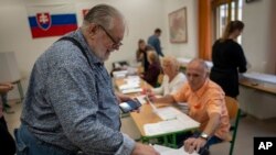 A voter casts his ballot at a polling station in Bratislava, Slovakia, Sept. 30, 2023. 