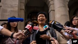 Journalist Bao Choy, center, speaks to members of the press after being cleared by the city's top court in Hong Kong, June 5, 2023. 