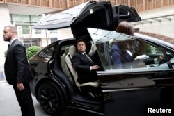 Tesla Chief Executive Officer Elon Musk gets in a Tesla car as he leaves a hotel in Beijing, China, May 31, 2023.