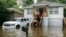 Savannah firefighters carry food to residents in the Tremont Park neighborhood that were stranded in stormwater from Tropical Storm Debby, Aug. 6, 2024, in Savannah, Ga.