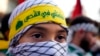 A member of Hezbollah's al-Mahdi scouts with a headband in Arabic that reads 'We will pray in Jerusalem' takes part in a protest in solidarity with the Palestinian people in Gaza, in Beirut, Lebanon, on Oct. 27, 2023.