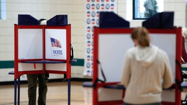 Voters fill out their ballots for the Michigan primary election in Grosse Pointe Park, Michigan, Feb. 27, 2024. Michigan is the last major primary state before Super Tuesday and a critical swing state in November's general election.
