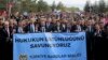 People, mostly lawyers, hold a banner that reads in Turkish, "We defend the supremacy of law," during a protest called by the Union of Turkish Bar Associations, in Ankara, Nov. 10, 2023.