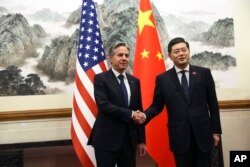 U.S. Secretary of State Antony Blinken, left, shakes hands with Chinese Foreign Minister Qin Gang, right, at the Diaoyutai State Guesthouse in Beijing, China, June 18, 2023.