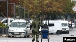A bomb disposal expert works at the scene after a bomb attack in Ankara, Oct. 1, 2023.