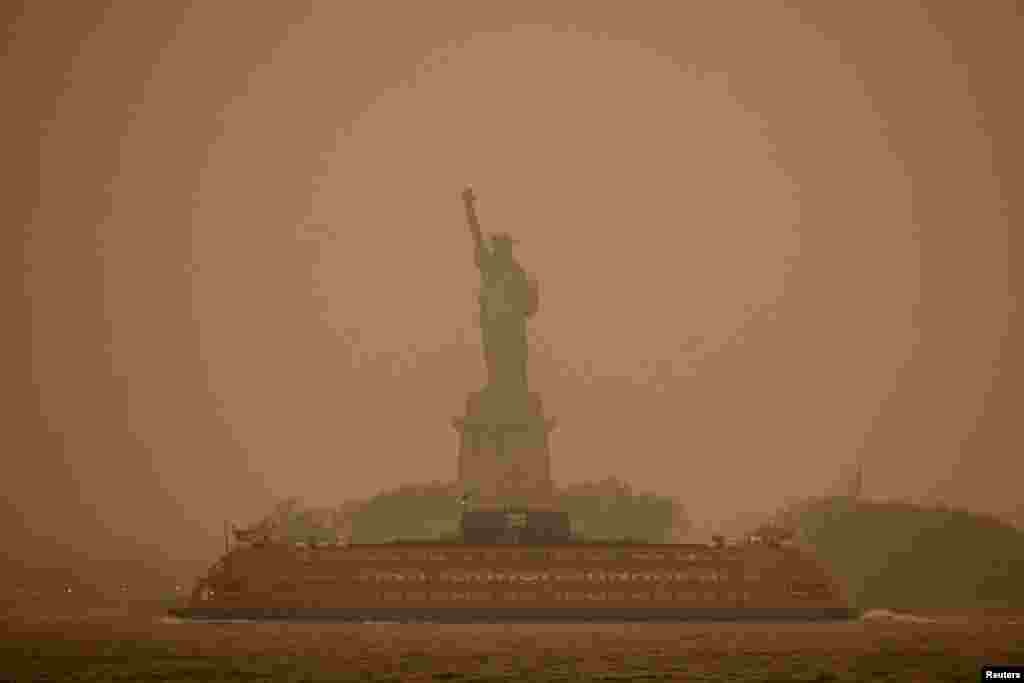 The Statue of Liberty is covered in haze and smoke caused by wildfires in Canada, in New York, June 6, 2023. 