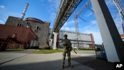 FILE - A Russian serviceman guards an area of the Zaporizhzhia Nuclear Power Station in territory under Russian military control, southeastern Ukraine, May 1, 2022.