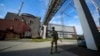 FILE - A Russian serviceman guards an area of the Zaporizhzhia Nuclear Power Station in territory under Russian military control, southeastern Ukraine, May 1, 2022. 