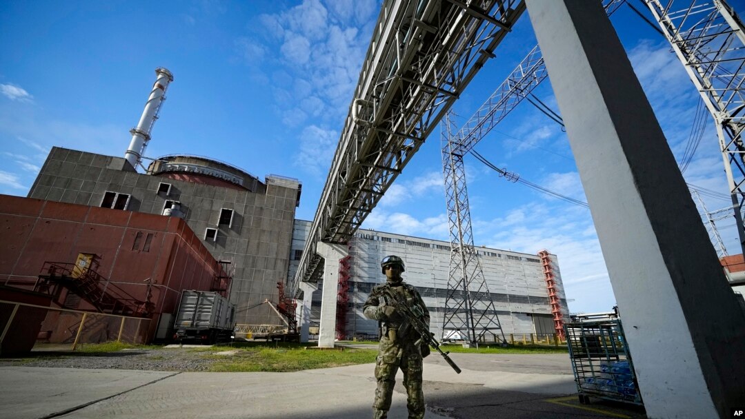 FILE - A Russian serviceman guards the Zaporizhzhia Nuclear Power Station in southeastern Ukraine, May 1, 2022. Power was restored at the plant Saturday after it was lost Friday, averting a "nuclear catastrophe," said Ukraine's energy ministry.