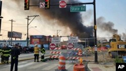 Image from the Philadelphia Fire Department shows officials working on the scene following a collapse on I-95 after a truck fire, June 11, 2023, in Philadelphia.