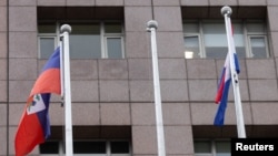 An empty flag pole where Nauru's flag used to fly is pictured next to flags of other countries at the Diplomatic Quarter which houses embassies in Taipei, Taiwan, Jan. 15, 2024. 