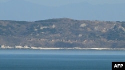 A general view shows the North Korean coastline with artillery bunkers as seen from a viewpoint on Yeonpyeong island, near the 'northern limit line' sea boundary with North Korea, Jan. 6, 2024. 