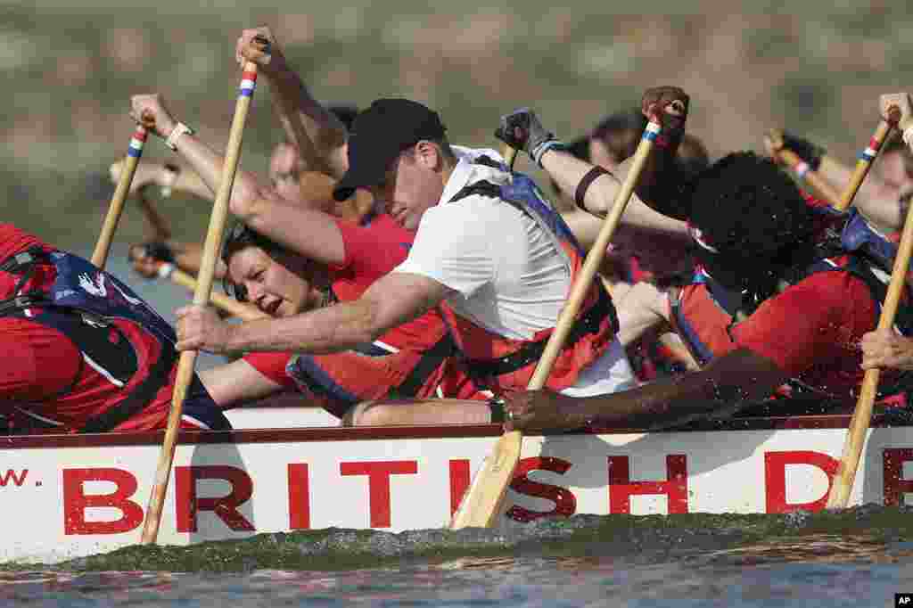 Britain's Prince William, center, participates in a dragon boat event in Singapore.