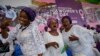 FILE - Women sing and dance during the International Women's Day celebration at the Mobolaji Johnson Stadium in Lagos, Nigeria, March 8, 2023. 