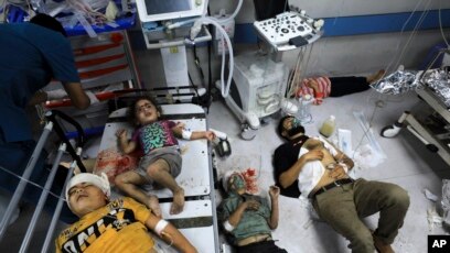 Palestinians wounded in the Israeli bombardment wait for treatment in Shifa Hospital in Gaza City Oct. 23, 2023.