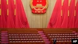 An official prepares prior to the second plenary session meeting of the National People's Congress (NPC) in the Great Hall of the People in Beijing, March 8, 2024.