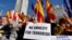 Protestors hold signs and wave Spanish flags during a demonstration called by the opposition party Partido Popular (PP) against the government's amnesty law, on the Plaza de Espana square in Madrid, Jan. 28, 2024.
