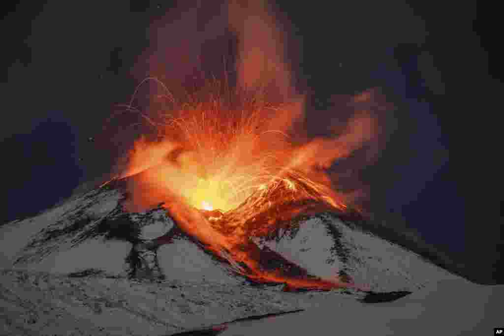 Lava erupts from snow-covered Mt Etna volcano, Sicily, Italy, Nov. 25, 2023. 