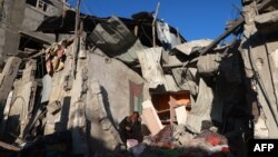 A Palestinian man checks the rubble of a building following Israeli bombardment on Jan. 18, 2024, in Rafah in the southern Gaza Strip.