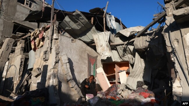 A Palestinian man checks the rubble of a building following Israeli bombardment on Jan. 18, 2024, in Rafah in the southern Gaza Strip.