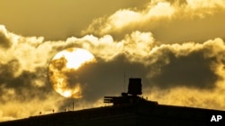 FILE - An air defense system is seen during sunset on the roof of the main building of the Russian Defense Ministry in Moscow, Nov. 1, 2023. Air defense systems have been put in many areas of Moscow as protection against Ukrainian drone attacks. 