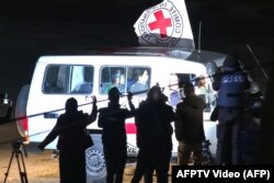 This image grab taken from AFPTV video footage on Nov. 25, 2023, shows an International Red Cross vehicle reportedly carrying hostages released by Hamas driving toward the Rafah border point with Egypt ahead of their transfer to Israel.