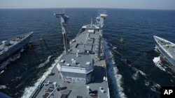 FILE - Pakistani warships conduct a refueling demo during naval drills in the Arabian Sea, off the coast of Karachi, Pakistan, Feb. 13, 2023.