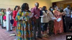 FILE - People become U.S. citizens during a naturalization ceremony at Mount Zion Temple in St. Paul, Minn., on June 21, 2023.(AP Photo/Trisha Ahmed)