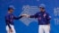 Two Taiwanese plays bump fists during men's baseball game on Oct. 3, 2023, against Hong Kong at the Asian Games in Hangzhou, China, where Taiwan's athletes are competing under the name Chinese Taipei. 
