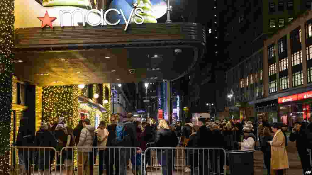 People wait in line outside Macy's department store before opening on "Black Friday" in New York City.