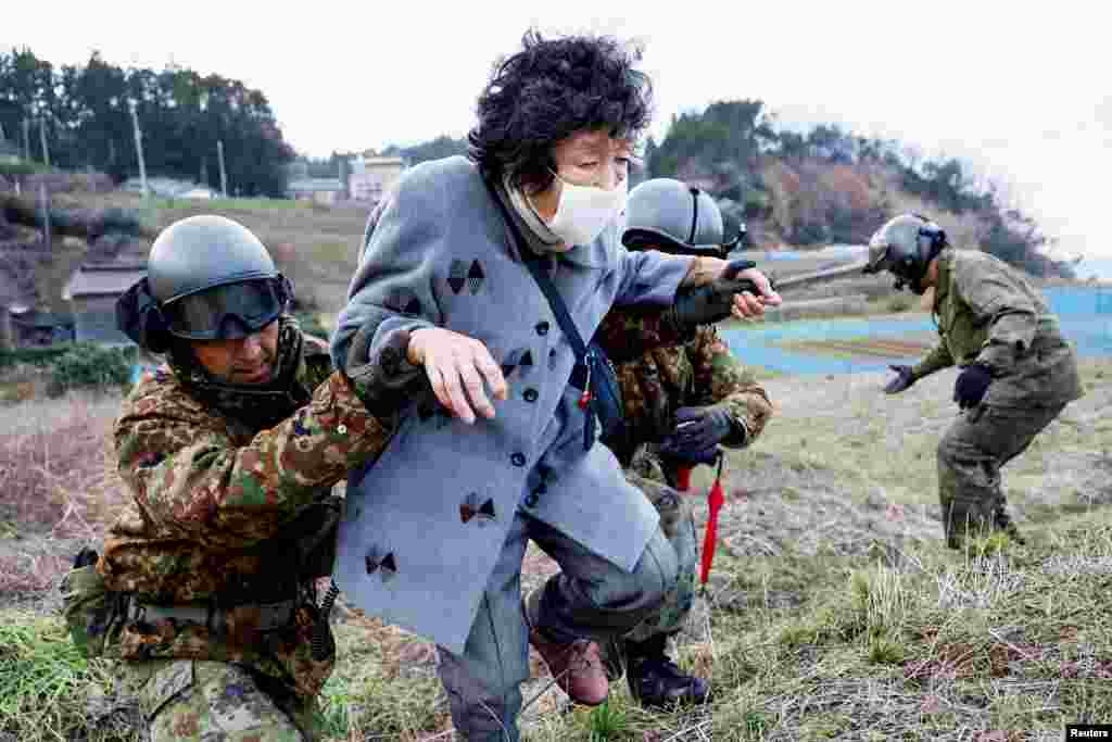 Members of Japan Self-Defense Force rescue residents in Fukamimachi, a village isolated after the earthquake, in Wajima, Ishikawa Prefecture, Jan. 6, 2024.