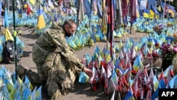 (FILE) A wounded Ukrainian serviceman visits a designated area for commemorating fallen Ukrainian soldiers at the Independence Square in Kyiv on August 29, 2024.